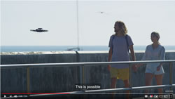 Autonomous drone taking pictures of couple walking on a pier.