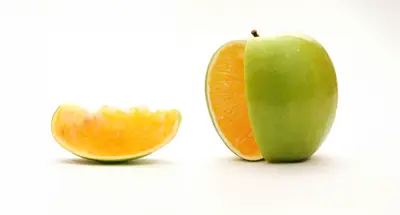 image of a green apple with slice cut out. The inside of the apple looks like an orange