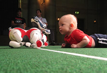 baby playing with robot