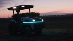 a tractor at dusk with LED lights and no driver