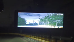 A view from the driver's seat shows a brightened image of a dark road on a wide dashcam.