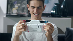 A front view of a person playing a white gaming device.