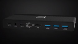 A small pocket-sized black device with USB, HDMI and other computer ports shown.