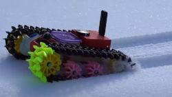 a toy remote control tank in the snow