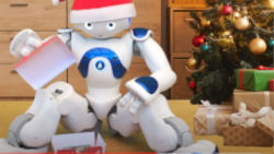A humanoid robot sitting and unwrapping a gift