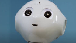a closeup of robot Pepper's face. It is white with big eyes and a small mouth