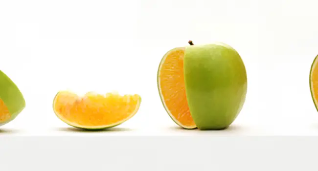 Agrobiotechnology image of apple with slice cut out. Inside of the apple looks like an orange