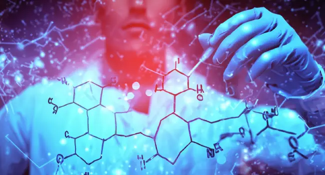 a drawing of a molecule on a see-through panel with a chemist standing behind it. 