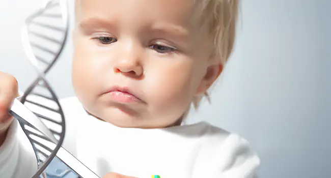 A picture of a cute baby examining a strand of DNA