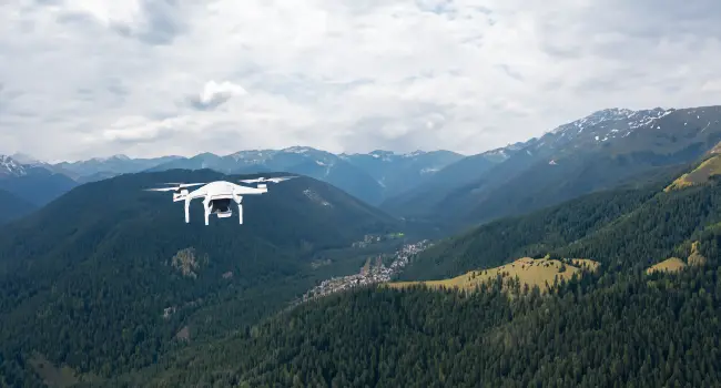 Mapping and surveying drone flying over a mountain village