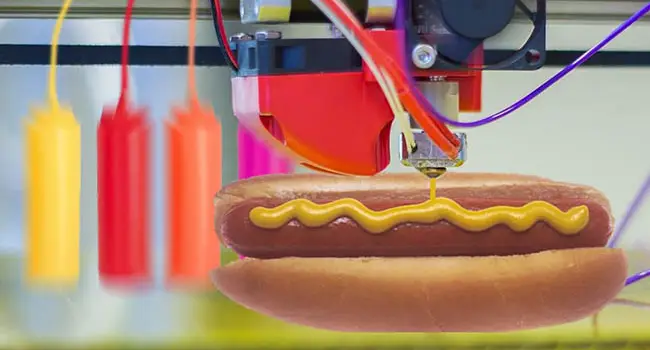 A hot dog in a bun with catsup and mustard being 3d printed