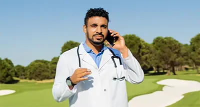 A doctor answers a call on a golf course