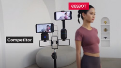 2 camera mounts are on a tripod tracking a person walking across a white minimalistic room. The text over the mount on the right reads Osbot and on the other it reads Competitor