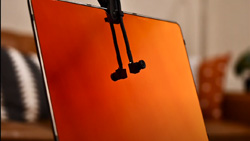 a closeup of a laptop screen that has a clip-on webcam that puts a small camera in the middle of the monitor