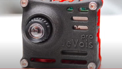 A closeup of a gray square camera.