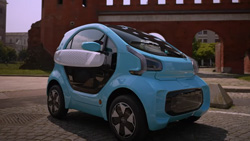 A blue compact 4-wheeled electric vehicle