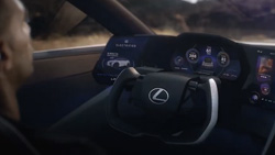 a view from the back right passenger seat shows a futuristic dashboard and steering wheel.