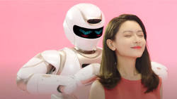The background is pink. A white and metallic gold humanoid robot is massaging a person's shoulder. The robot has a black capsule-shaped screen that wraps around the front of the head. It has blue LEDs shaped in a V for eyes.