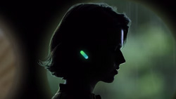 The silouette of a person wearing lighted earbuds