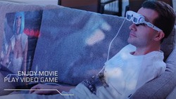 a closeup of a person wearing, bulky, white, augmented reality glasses relaxing on a couch watching a simulated AR movie floating in mid-air.