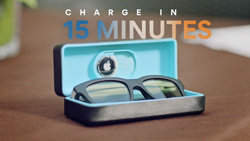 A closeup of a pair of black, thick rimmed sunglasses in a light blue case. The text reads Charge in 15 minutes.