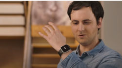 a man is looking at his watch and making a hand gesture